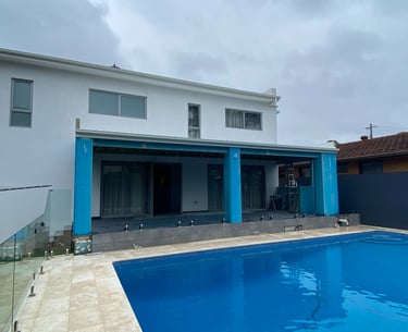 foreground pool with modern home extention in progress