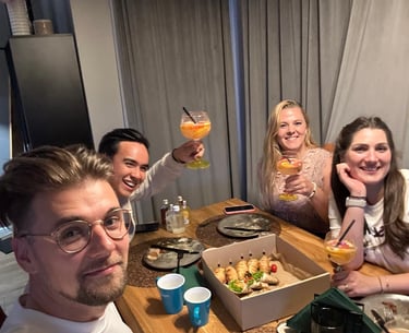Friends toasting and enjoying homemade food during warm evening in Łódź