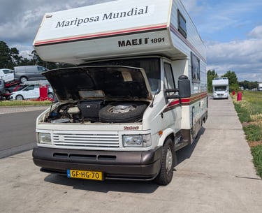 Campervan parked on a highway shoulder near Berlin after sudden brake failure during road trip.