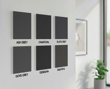 Six textured grey fabric color swatches labeled on a white wall in a modern room.