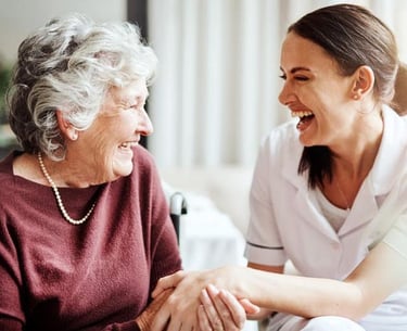 nurse and elderly woman holding hands