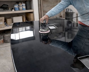 a man is sanding a black counter top