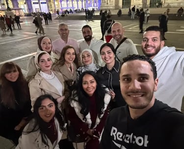 A large group of Vitatech members taking a group selfie at night in Milan Event - Italy.