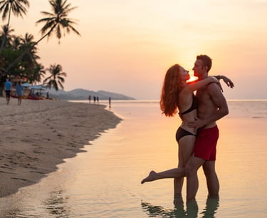 a sugar baby and sugar mommy kissing on the beach