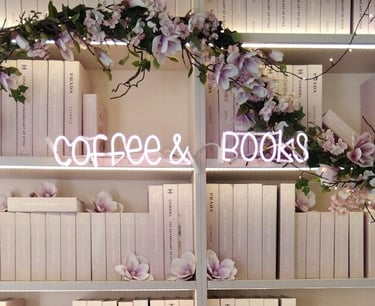 a book shelf with books and flowers on it