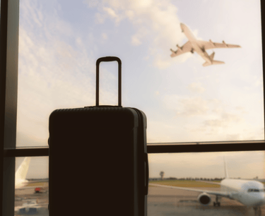 a suitcase and a suitcase in front of a window