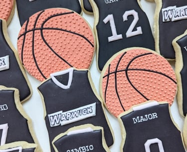 Basketball and jersey cookies for a basketball team in black, pink, and orange