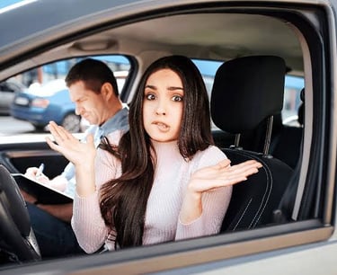 Anxious young woman taking a driving test with a nervous expression while the instructor takes notes.