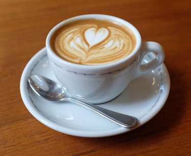 a cup of coffee with a heart shaped design on the side