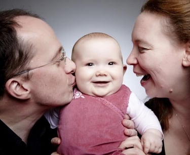 smiling man and woman with baby girl 