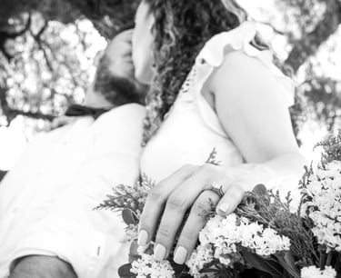 a man and woman holding flowers in a tree