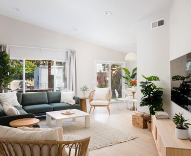 a living room with a green couch and a television