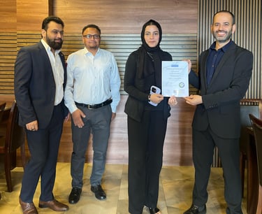 SESI Officials presenting a certificate of achievement to a female Personal trainer.