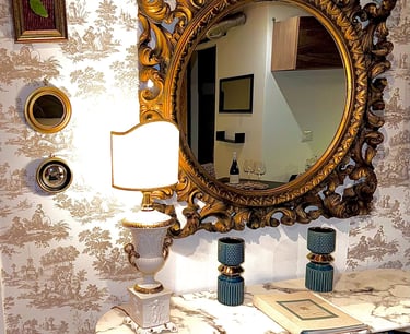 Vintage gold-framed mirror and table lamp in stylish Sicilian villa interior