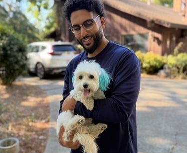 Fahad Aldulaymi holding a puppy at Barkbnb 