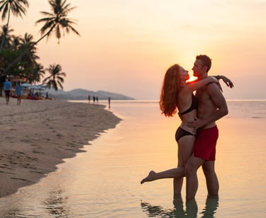 a sugar baby and sugar mommy kissing on the beach