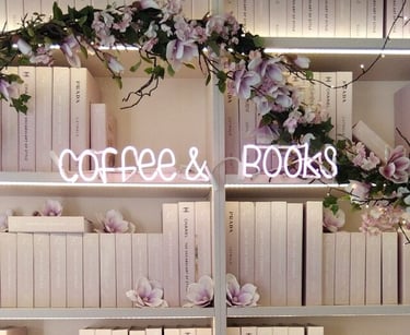 a book shelf with books and flowers on it