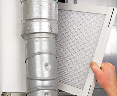 a person holding a duct with a air filter