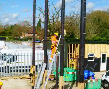 Our trainee on ladder against our training telephone pole