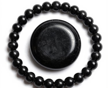 Handcrafted decorative stone disk with black and white rings surrounded by polished agate beads.