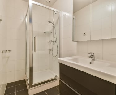 Small bathroom with square shower tray and basin
