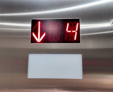 elevator indicator showing the elevator is on the 4th floor and an arrow pointing down