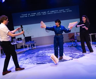 Three people on the surface of the moon, casting papers out across it