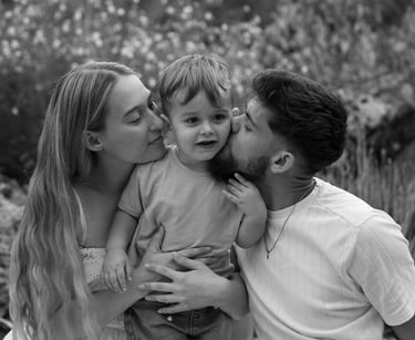 family portraits with their son in the middle