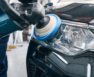a person polishing a car's headlight