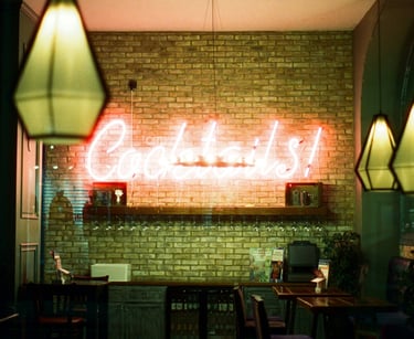 a neon sign that says' Coctails in a bar.Hospitality Startup Guidance with Timea Pokol Consultant