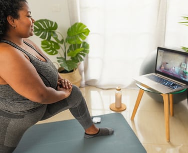 a woman in a gray tank top and gray pants having remote physiotherapy at home with a virtual physio