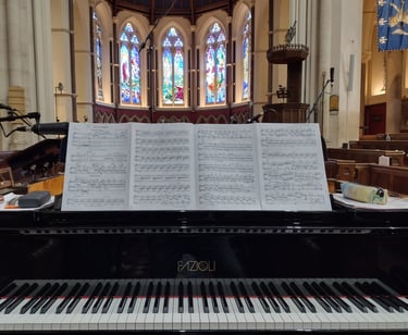 Photo of a grand piano in a chapel