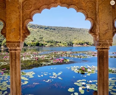 View of Jait Sagar Lake framed through the ornate arches of Sukh Mahal in Bundi.