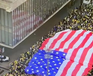 a large flag - drapeded flag on a city street