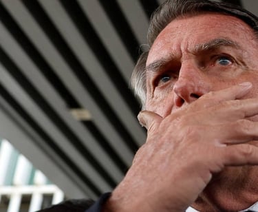 a man in a suit and tie is holding his hand to his chin