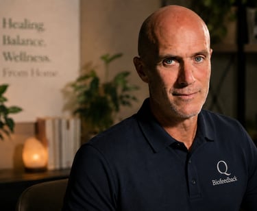 A portrait of a male biofeedback specialist in a wellness office with plants and warm lighting.