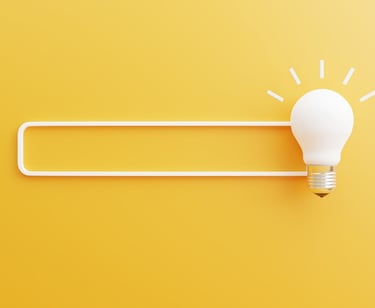 a light bulb bulb sitting on top of a white light bulb - Illford Academy