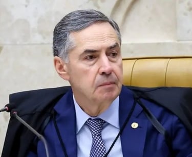 a man in a suit and tie is sitting at a microphone