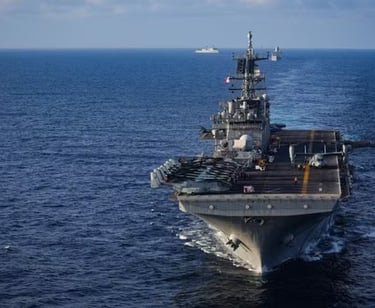 a large ship in the water with a large ship in the background
