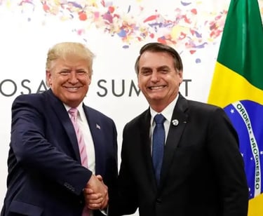 a man in a suit and tie standing next to a flag