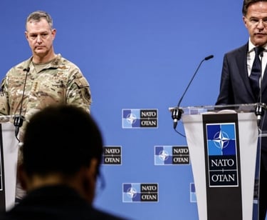 two men in suits and ties standing at podiums