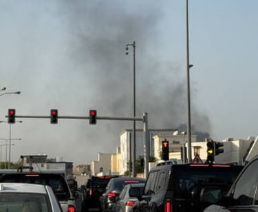 a traffic light on a busy street with smoke billowing
