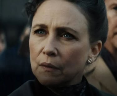 a woman with a black hair and a man in a suit