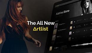 Artlist affiliate / a woman in a black dress standing in front of a computer screen