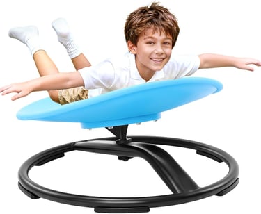 Smiling boy playing on a blue sensory swivel chair for kids balance and coordination training.