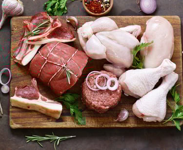 a cutting board with meat and vegetables on a cutting board