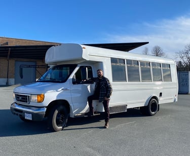 a bus driver standing in front of a tour bus