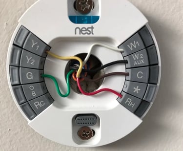 Nest Thermostat Installation photo with message in red to read instructions before installing thermostat by yourself