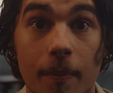 a man with a mustache and a tie on his neck