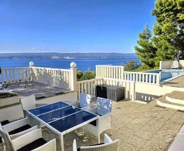 The photo depicts the courtard dining set as well as parts of the eastern sun terrace and pool.